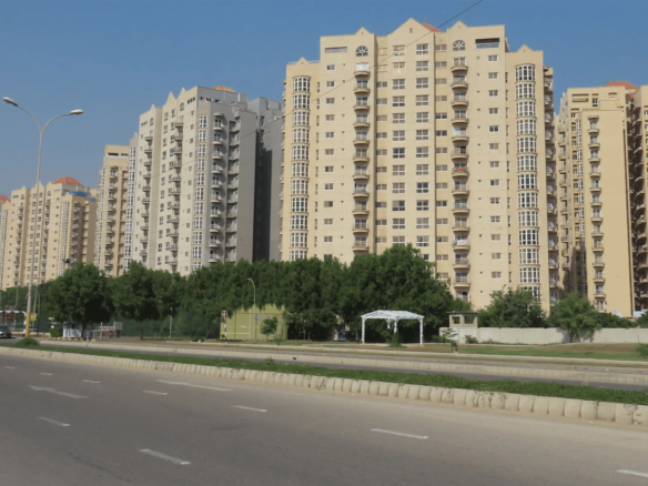 Stunning exterior view of the fully renovated Creek Vista apartments in DHA Phase 8 Karachi, showcasing modern architecture against a scenic backdrop