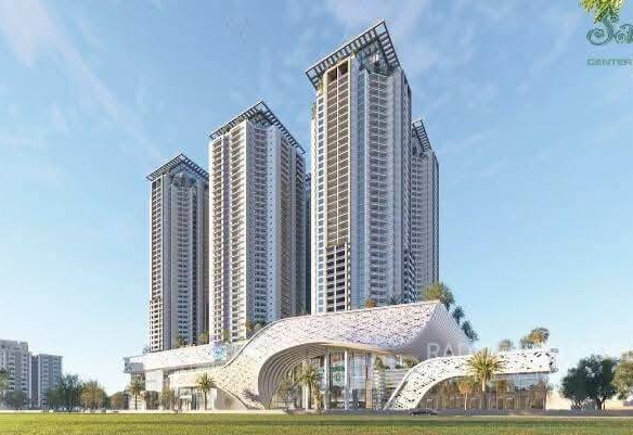Three modern high-rise towers and futuristic curved entrance at Saima Center Point in Karachi, with palm trees and landscaped