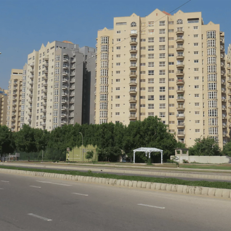 Stunning exterior view of the fully renovated Creek Vista apartments in DHA Phase 8 Karachi, showcasing modern architecture against a scenic backdrop