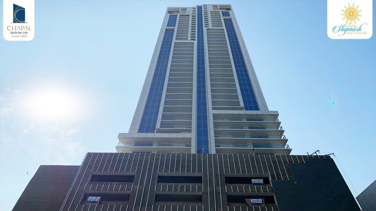 Towering 50-storey Chapal Skymark with sleek blue and white facade under sunny blue sky