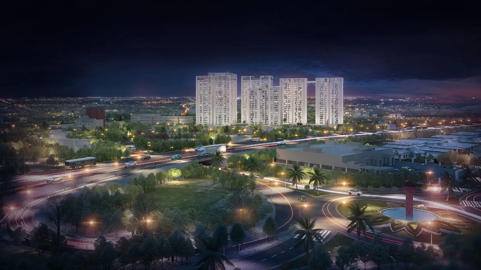 Night aerial view of Pearl Towers high-rise apartments in Askari 11 Lahore surrounded by greenery roads and roundabout